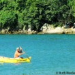Local rowing in small boat, Praia Vermelha, Paraty, Brazil Local rowing in small boat
