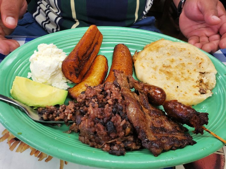 Grilled meat, chorizo, pupusa, plantain, cheese and avocado